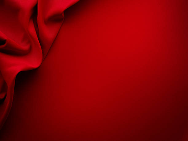 Beautiful red silk satin background. Luxury background with copy space for text, design. Flat lay, top view. Birthday, Christmas, Valentine design element.