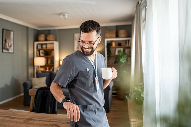 istock Male nurse enjoying coffee break at home 2244093555