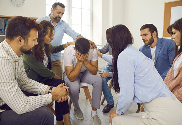 istock Young businessman in trouble shared his problem with colleagues who comfort him. 2244095153