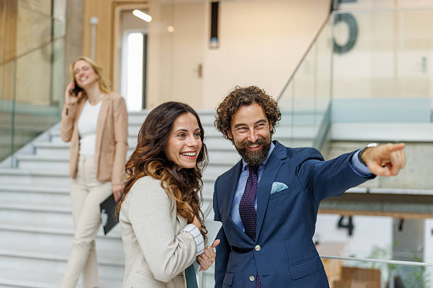 istock Business people talking and pointing in a corporate setting 2244096102