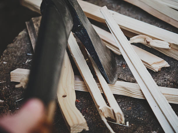 istock Hand Holding Axe over Wood Stump with Scattered Wood Chips 2244097504
