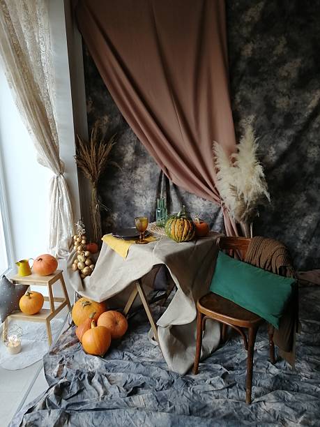 istock Autumn interior decoration with pumpkins on a table and floor. Fall Thanksgiving, Halloween holiday harvest display with dry grass. 2244099804