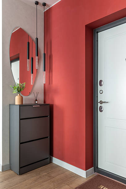 istock Modern Hallway Interior with Red Wall and Pendant Lights 2244101225