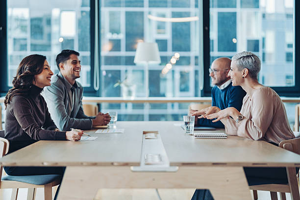 istock Business persons sitting opposite at a conference table and negotiating 2244101896