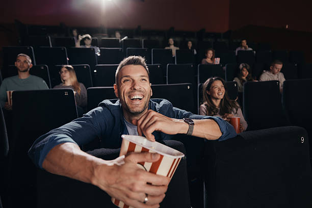 istock Happy man enjoying while watching a movie in cinema. 2244101938