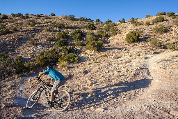 istock Mountain biker rides trail in desert 2244102609