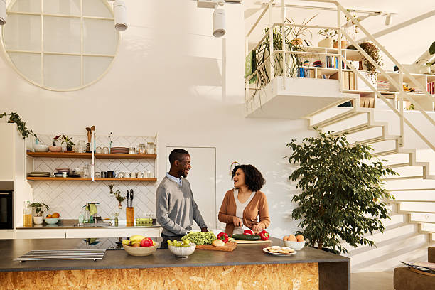 istock Happy black couple talking while preparing food in the kitchen. 2244102776