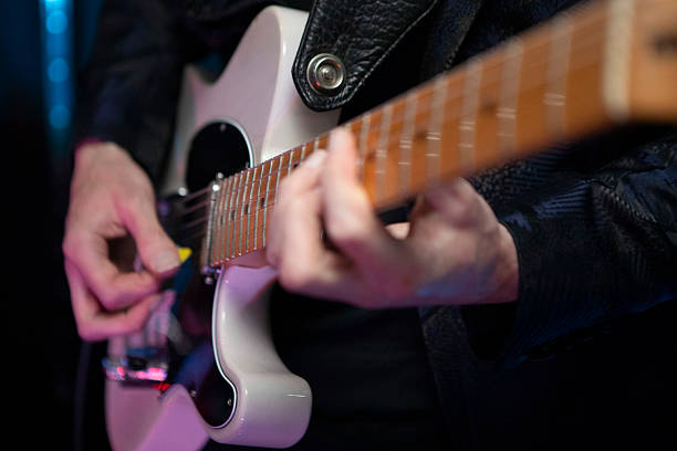 istock Close-up of hands playing an electric guitar 2244104444