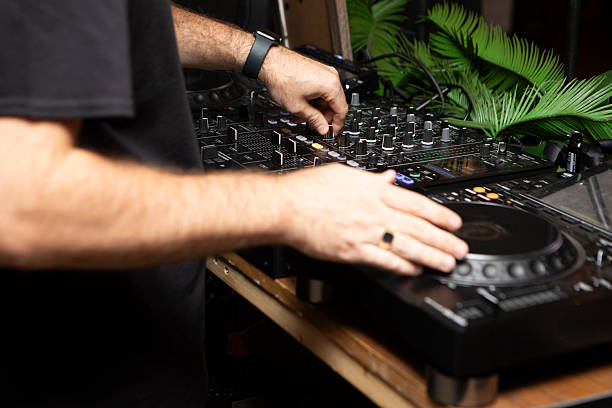 istock DJ hands working a mixing desk at a party 2244104497