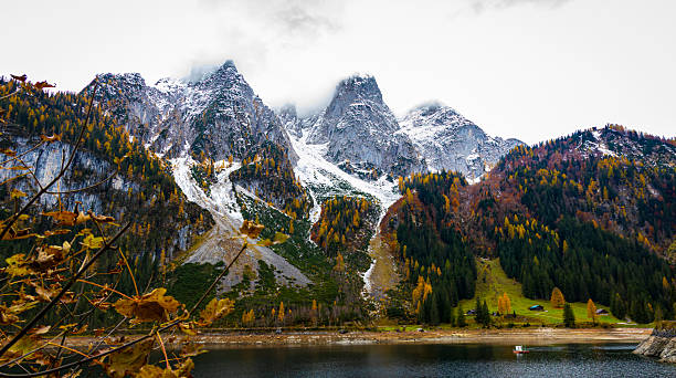 istock Autumn's First Snow Track Gosausee with Dachstein mountain summit and blue lake as idyllic colorful autumn scenery background 2244107903