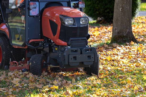 istock Leaf removal with a ride-on mower in a public park 2244109570