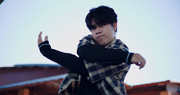 istock Young Asian man dances alone with full energy in an open-air public pavilion. 2244110732