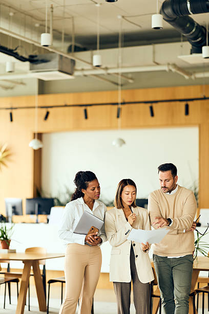 istock Professional Team Discussing Documents During a Meeting in a Modern Open Office Space 2244112856