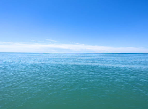 istock Blue sea water background and sun reflections.. Waves water surface with blue sky background 2244112966