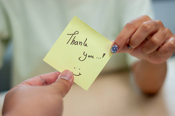 istock Gratitude exchange gesture office setting action moment informal environment close-up viewpoint 2244114055