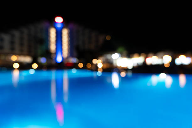Blurred swimming pool at the night with bokeh lights