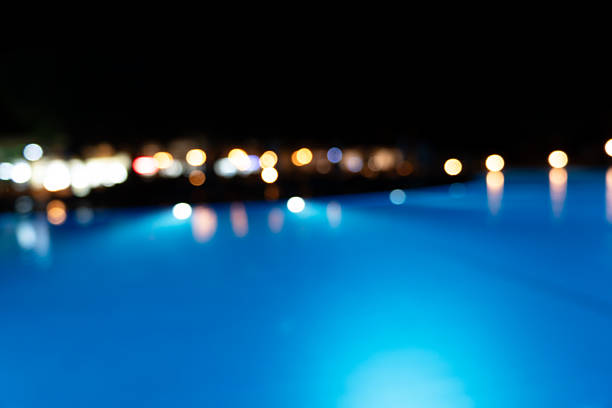 Blurred swimming pool at the night with bokeh lights
