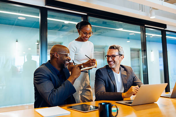 istock Business professionals sharing ideas and working together in office setting 2244117268