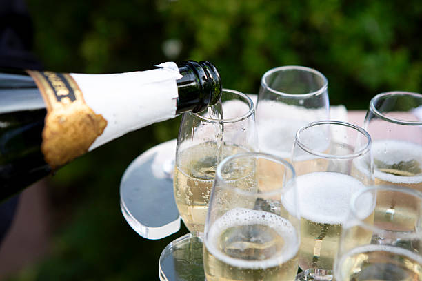 istock Pouring champagne from a bottle into glasses 2244119466