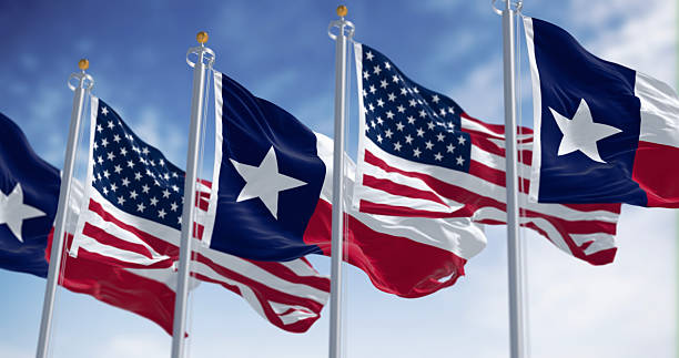 istock Texas state flags waving in the wind with american flag 2244120609