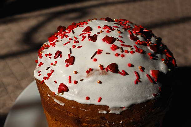 Easter cake decorated with sugar sprinkles. Delicious Easter cake decorated with red sprinkles. Traditional Easter cake with sugar sprinkles