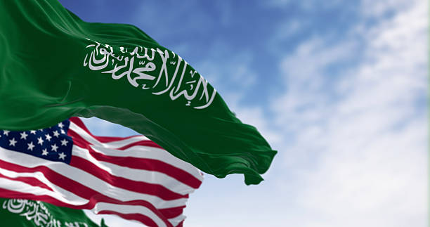 istock Saudi Arabian and American flags waving together in sky, 3D render 2244120639