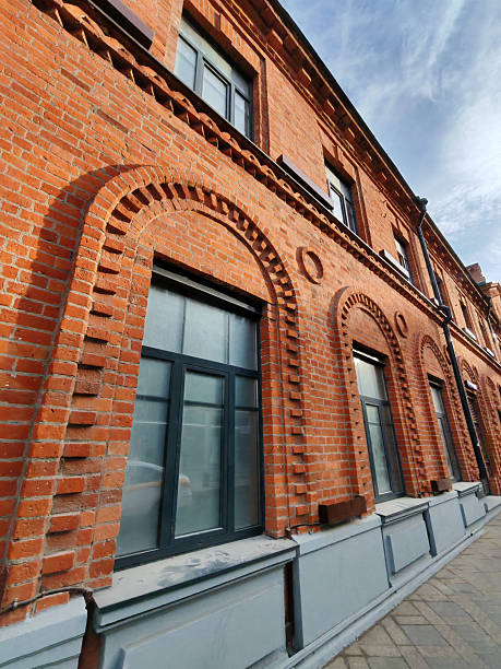 istock A vibrant red brick wall with arched window frames and decorative brick patterns. The shot captures the elegance of historic construction and urban restoration. 2244121910