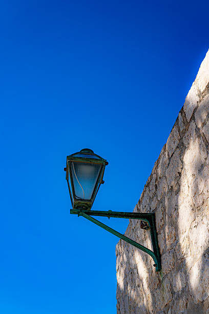 istock Street lamp on a stone wall 2244123728