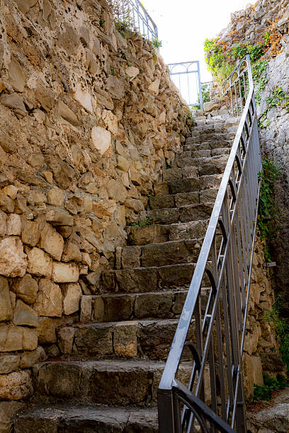 stone stairs on an old house in the town of Rab with a makeshift iron fence, Croatia, Mediterranean