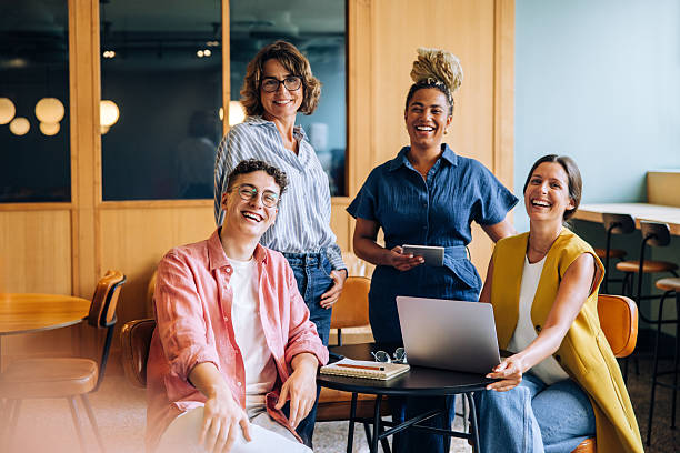 istock Happy group of coworkers enjoying teamwork in modern workplace 2244124234