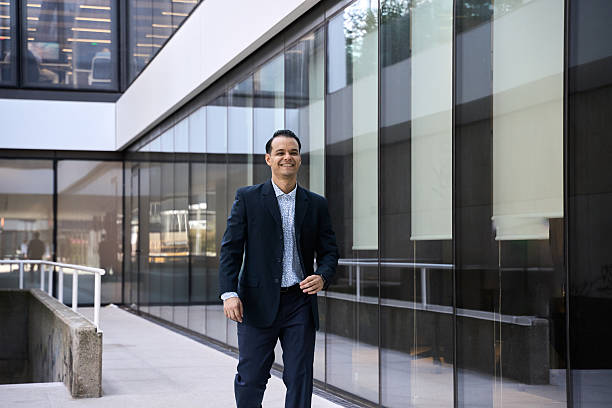 istock Latin businessman walking, smiling, in modern office building 2244124290