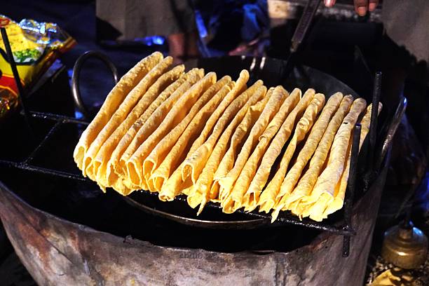 istock Rolled papad cones arranged on grill 2244124622