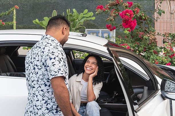 istock Happy couple talking by car enjoying date 2244126211