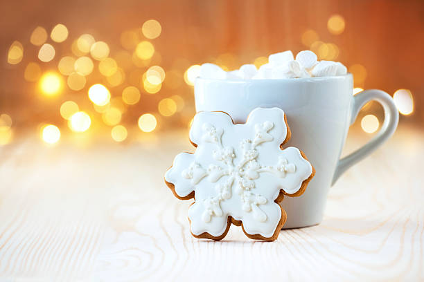istock Christmas Gingerbread Cookies decorated with icing on background with christmas lights. Christmas tree. Greeting card. 2244126513