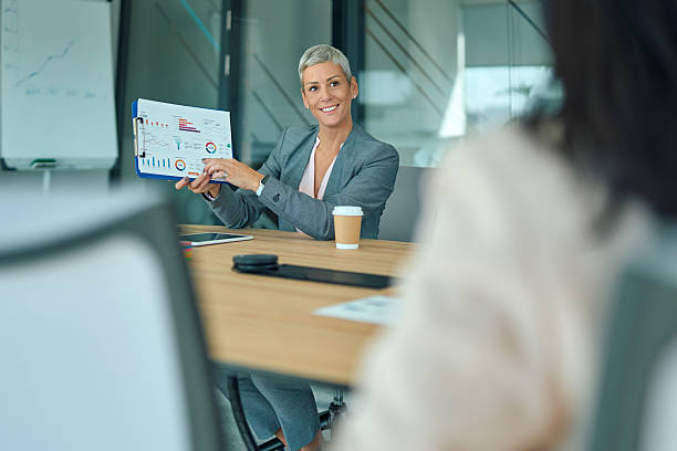 istock Businesswoman presenting data report during office meeting 2244127791