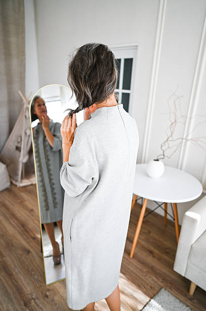 istock Woman getting ready looking in mirror reflection at home 2244128415