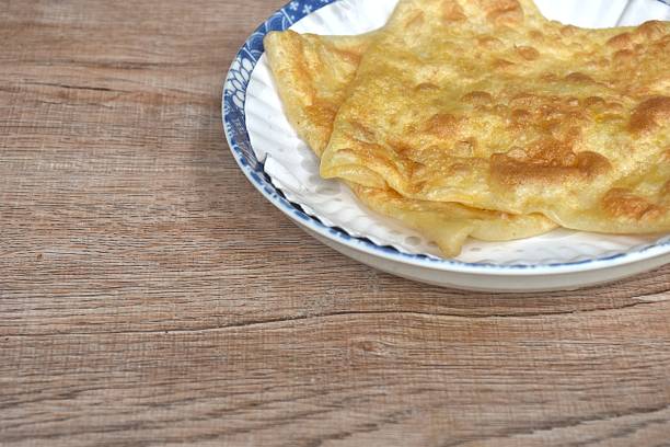 istock fried roti southern flat bread on white paper tray 2244130670