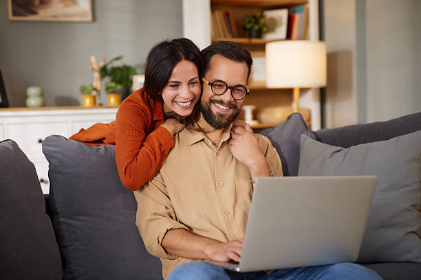 istock Happy couple relaxing enjoying online content at home 2244132893