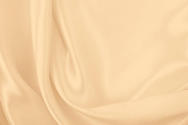 istock Smooth elegant golden silk or satin luxury cloth texture as wedding background. Luxurious background design. In Sepia toned. Retro style 2244134574