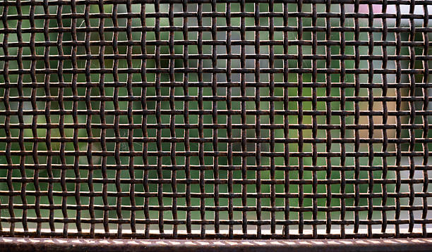 istock Chain link fence pattern with blurred background and sunlight on sunny day. 2244135221