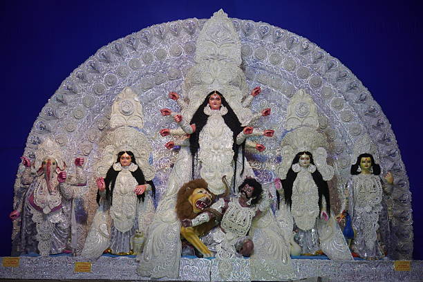 Durga Puja Idol with Family on Blue Backdrop in a Durga Puja Pandal