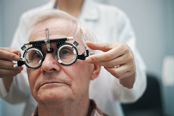 istock Senior Man Undergoing Eye Examination with Optometrist Adjusting Phoropter 2244137757