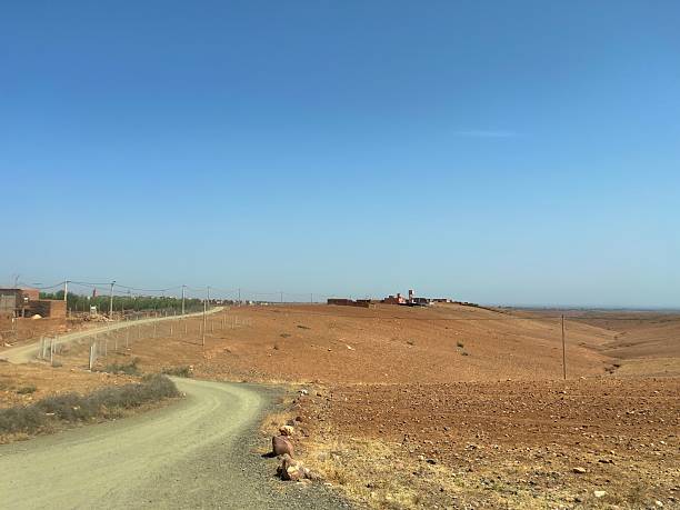 istock Morocco rural landscape with dirt road and distant village 2244137883