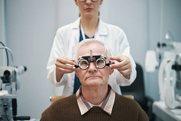 istock Senior Man Undergoing Eye Examination with Female Optometrist 2244138814