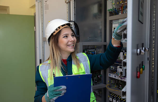 istock Female Engineer Performing Hands-On Inspection and Maintenance in Advanced Control Room of Renewable Energy Facility 2244141985