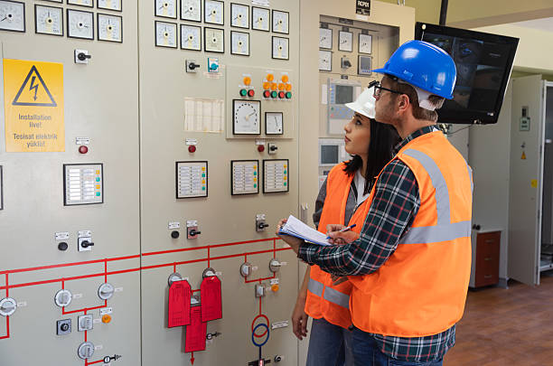 istock Engineers Collaborating in Modern Control Room of Renewable Energy Facility for System Monitoring and Safety 2244141992