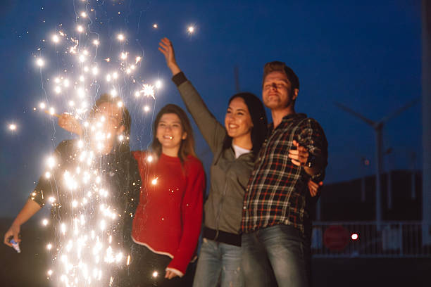 istock Best friends celebrating with sparklers at night 2244142331
