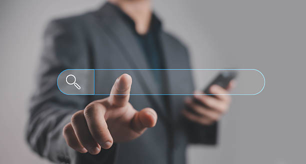 istock Businessman pressing digital search bar interface with magnifying glass icon, symbolizing online search, internet browsing, data finding, digital marketing, and web technology innovation. 2244144277
