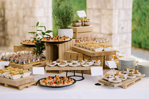 Elegant outdoor buffet setup featuring a variety of gourmet appetizers, finger foods, and hors d'oeuvres for events or catering.