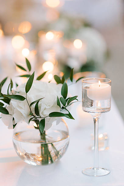 istock Romantic wedding table with candles and white flowers 2244146498